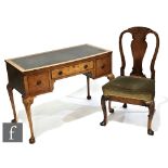 A Queen Anne style walnut writing desk, the leather inset top over a frieze drawer flanked by two