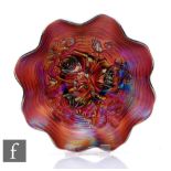 An early 20th Century Carnival glass footed bowl with wave edged rim, by Northwood, relief moulded