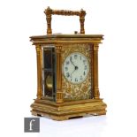 A 19th Century brass carriage clock with push button repeat, the Arabic dial and pierced floral face