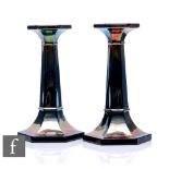 A pair of early 20th Century Carnival glass candlesticks by Sowerby, of tapering hexagonal form,