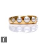 An early 20th Century 18ct ring set with five graduated split pearls, weight 6.3g, ring size M, some