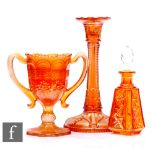 Three pieces of early 20th Century carnival glass in marigold, a loving cup by Fenton relief moulded