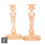 A pair of early 20th Century Carnival glass candlesticks by Riihimaki, relief moulded in the