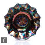 An early 20th Century Carnival glass bowl with wave edged rim, by Crown Crystal, relief moulded to