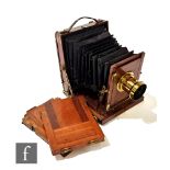 A Victorian mahogany and brass mounted half plate camera with maroon bellows labelled Perken,
