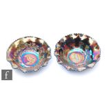 Two early 20th Century Carnival glass bowls with wave edged rims, by Crown Crystal, each relief