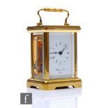 A 20th Century miniature brass carriage clock by Gluck & Son London, on bracket feet, height 8cm.