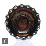 An early 20th Century Carnival glass footed bowl with deep body and wave edged rim, by Crown