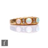 An 18ct hallmarked seven stone opal and diamond ring, three opals spaced by two pairs of diamonds,