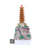 A Clarice Cliff for A.J. Wilkinson flower bowl centre block modelled as a pagoda above a rocky base,