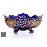 An early 20th Century Carnival glass four footed banana bowl with deep body and wave edged rim, by