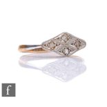 An early 20th Century 18ct diamond ring comprising four diamonds to a platinum flat head, weight 1.