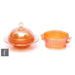 Two pieces of early 20th Century carnival glass, a butter dish by Leerdam relief moulded in the