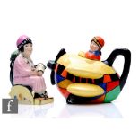 A contemporary Carlton Ware novelty teapot modelled as Clarice Cliff flying a bi-plane with bold