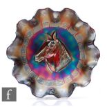 An early 20th Century Carnival glass footed bowl with wave edged rim, by Dugan, relief moulded to