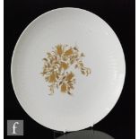 A Rosenthal Studio-linie charger decorated with a design by Bjorn Wiinblad with gilt flowers and