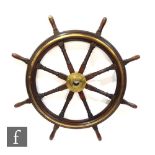 A 19th Century mahogany and brass ships wheel with central fixed boss and eight radiating spindles