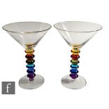 A set of six contemporary cocktail glasses, each with a clear conical bowl above a rainbow