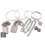 A small parcel lot of assorted silver jewellery to include four bangles, two Victorian lockets, a
