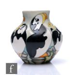 A small Moorcroft Pottery Four Star Collectors Club vase decorated with tubelined puffins, impressed