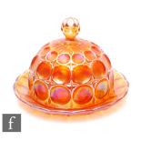 An early 20th Century Carnival glass butter dish and cover by Brockwitz, relief moulded in the