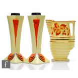 A pair of 1930s Art Deco Etonia Ware Odeon style vases in yellow and orange with black detailing,