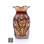 An early 20th Century Carnival glass vase of ovoid form with flared rim, by Karhula, relief