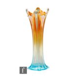 An early 20th Century Carnival glass vase of sleeve form with moulded pillars and wave rim, by