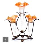 An early 20th Century epergne with three graduated iridescent amber trumpets mounted to a metal wire
