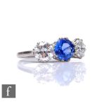 An 18ct white gold sapphire and diamond three stone ring, central cornflower blue sapphire 1.25ct