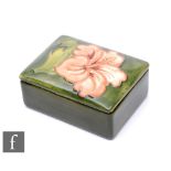 A small Walter Moorcroft trinket box and cover of rectangular section, decorated in the Coral
