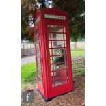 A 1950s K6 red cast iron telephone box, the domed top over four sides with glass panels named '