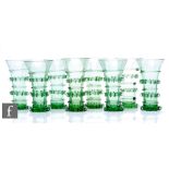 A set of contemporary hand blown reproduction green drinking glasses in the style of a German