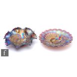 Two early 20th Century Carnival glass footed bowls with wave edged rims, by Northwood, each relief