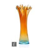 An early 20th Century Carnival glass vase of slender tapering form with wave rim, by Imperial, in