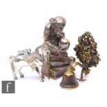 An early 20th Century plated table lighter modelled as a seated ape holding a skull and sitting on