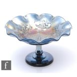 An early 20th Century Carnival glass comport with wave edged rim, by Crown Crystal, relief moulded
