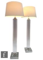 Eichholtz - A pair of Art Deco style torchere style floor lights, the square plinth chrome base