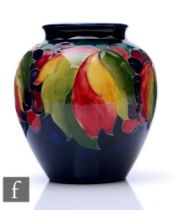 William Moorcroft - A small vase of high shouldered ovoid form with everted rim, decorated in the