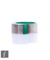 Carole Leonard - A contemporary silver and Perspex ring, of spiral form with green Perspex core,