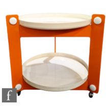 Luigi Massoni - Harvey Guzzini - A two-tier cream and tangerine orange acrylic trolley table of