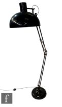 After Anglepoise - A black floor lamp, the domed base extending to an adjustable arm and shade,