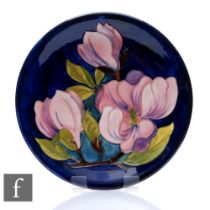 Moorcroft Pottery - A plate of circular form, shape 783/10, decorated in the Magnolias pattern