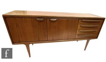 John Herbert - A. Younger Ltd - A teak sideboard, fitted with an arrangement of four drawers