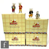 A collection of Rupert figures, comprising four boxed Royal Doulton with certificates, Rupert,