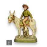 A large late 19th to early 20th Century Royal Dux figure group modelled as a young boy riding a