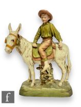 A large late 19th to early 20th Century Royal Dux figure group modelled as a young boy riding a