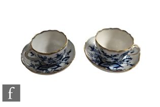 A pair of late 19th to early 20th Century Meissen split handle tea cups and saucers, each hand