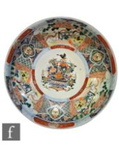 A large Japanese Imari bowl, the central jardinere design decorated with radiating panels of figures