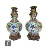 A pair of Chinese cloisonne vases, each of bottle form, rising to a slender neck applied with cicada